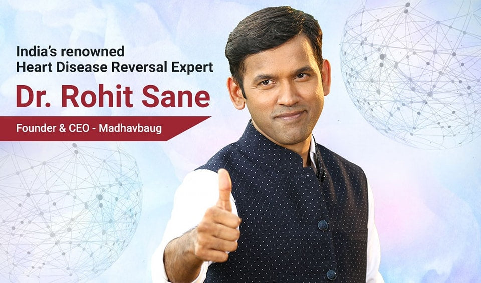 Dr. Rohit Sane, a renowned heart disease reversal expert, giving a thumbs up with a blurred network design in the background.